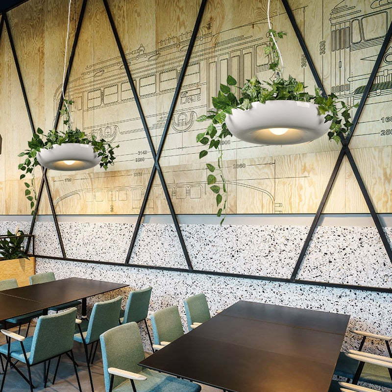 Modern metal pendant light with plants in living room.