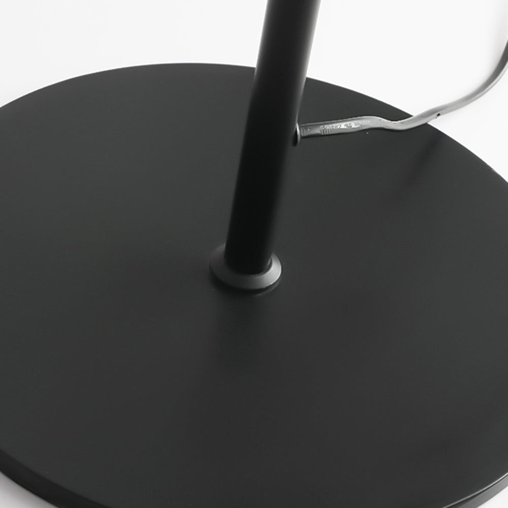 Avi Floor Lamp: Black metal base detail.