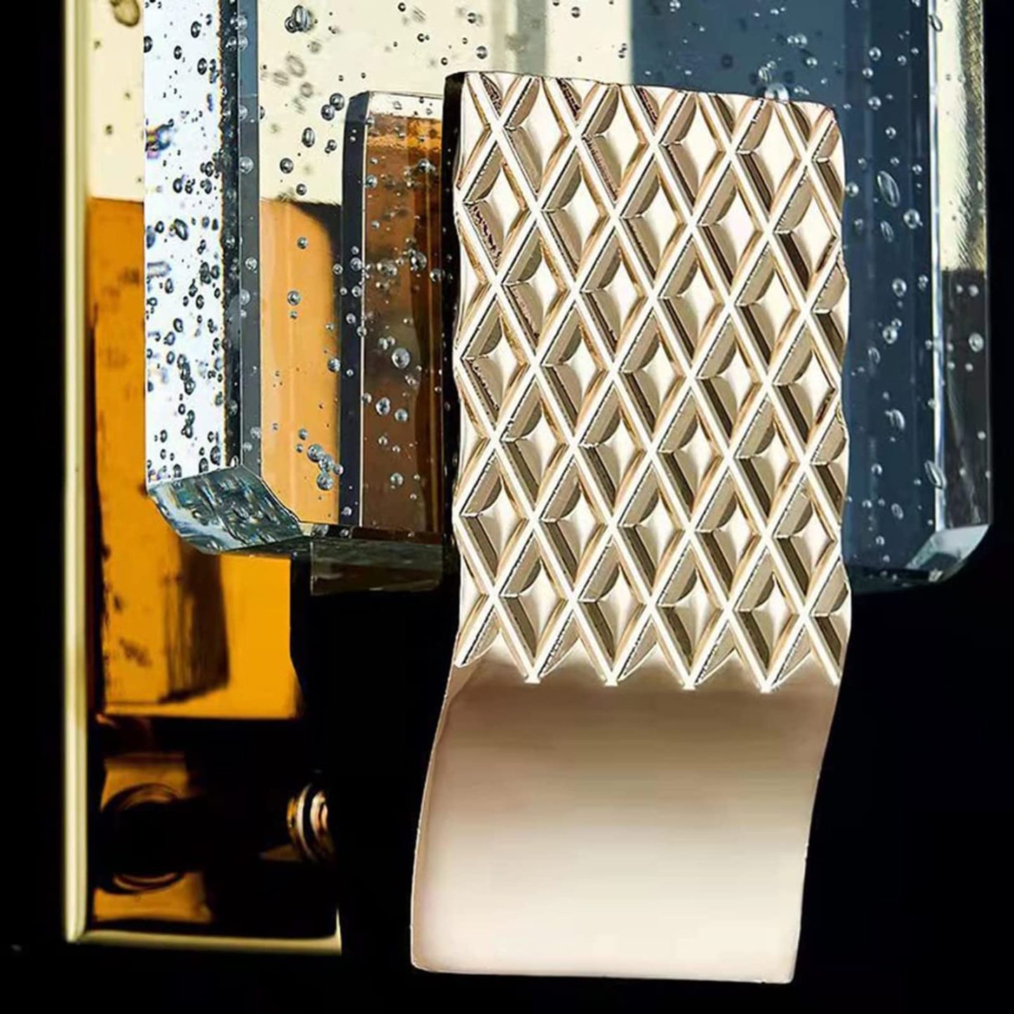 Kajetan wall lamp detail: metallic diamond pattern, gold finish
