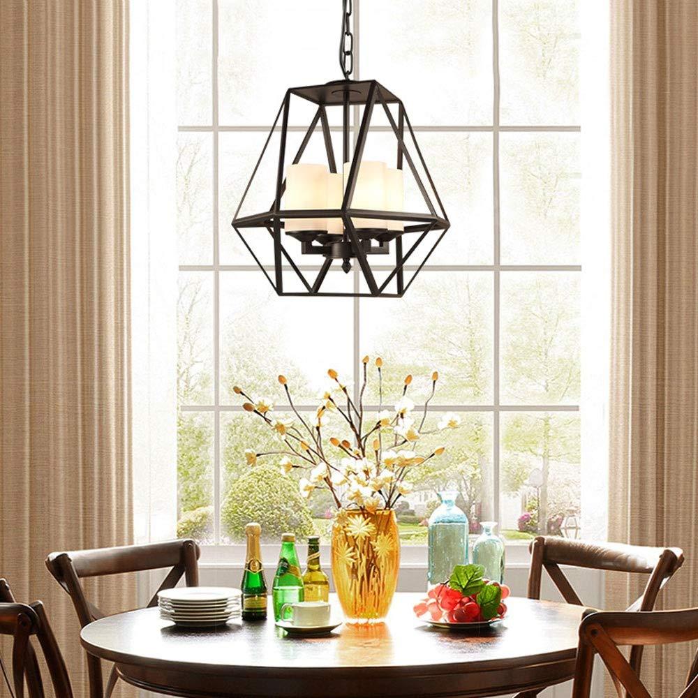 Industrial pendant light over dining table. Black metal cage design.