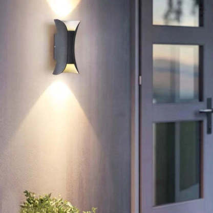 Orr LED wall light illuminating outdoor wall next to door.