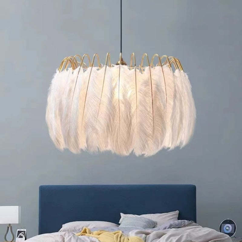 White feather pendant light over bed