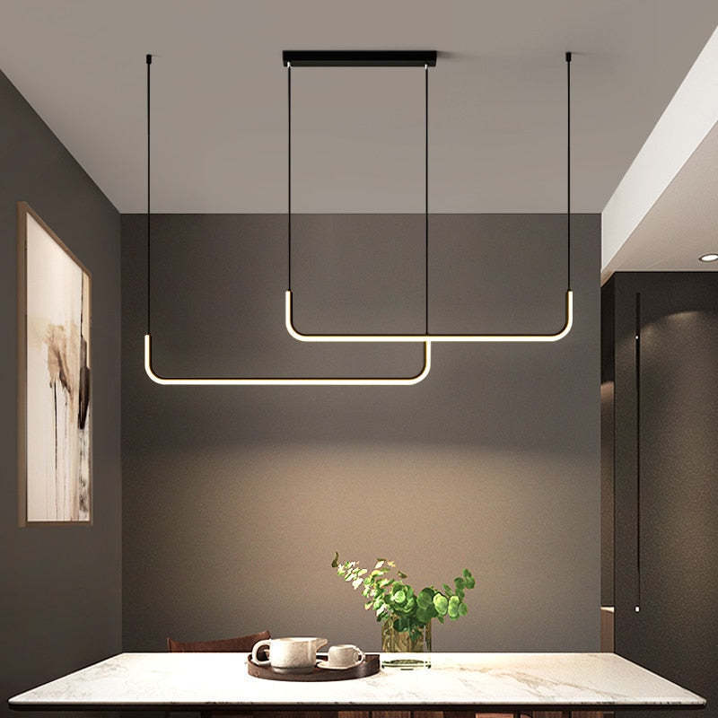 Modern linear pendant lighting above dining table.