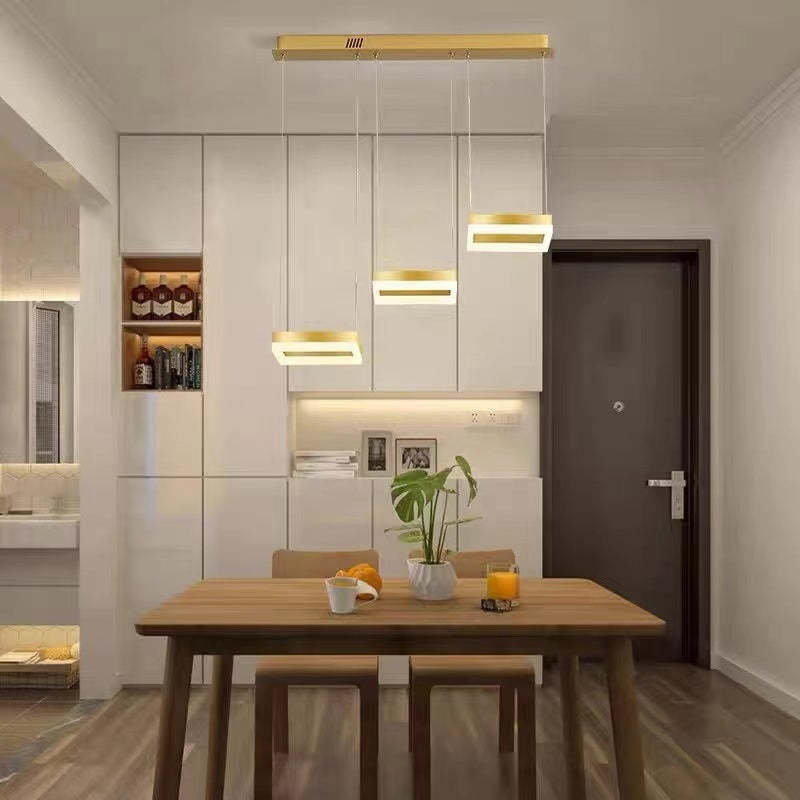 Modern gold pendant light over dining table