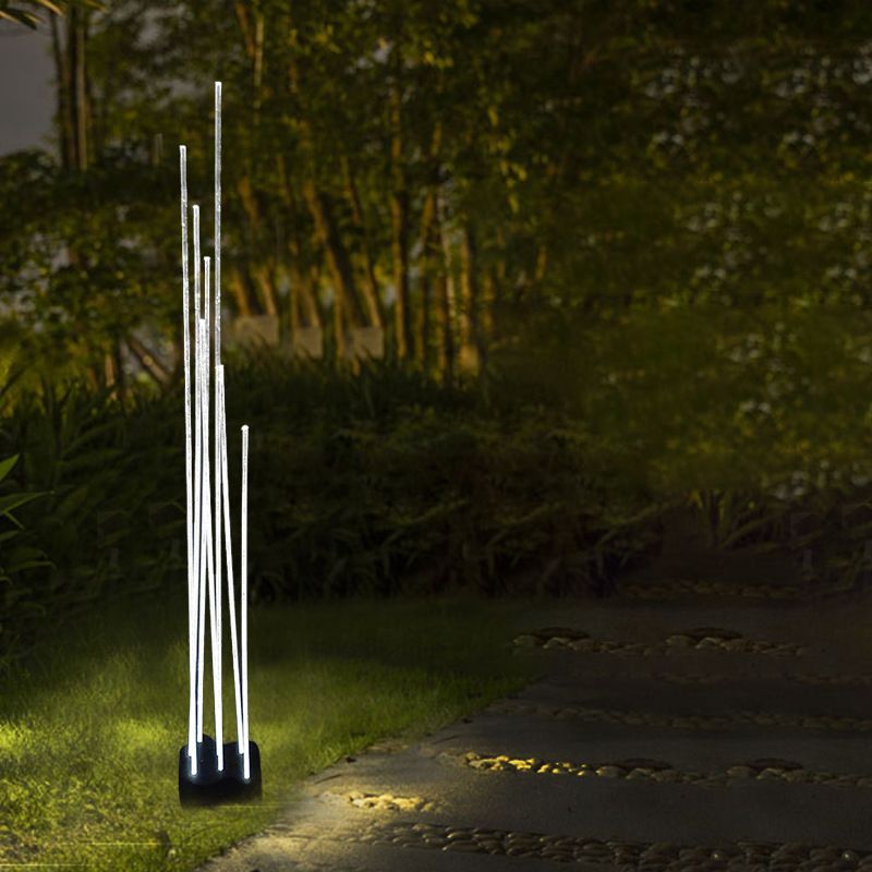 Riley LED Outdoor Ground Light illuminating garden path at night