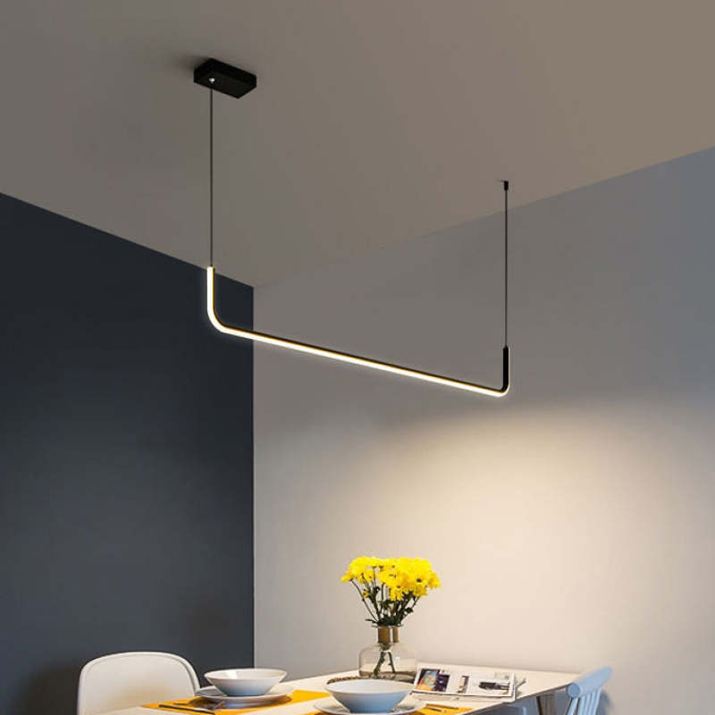 Modern linear pendant light over dining table by Las Sola