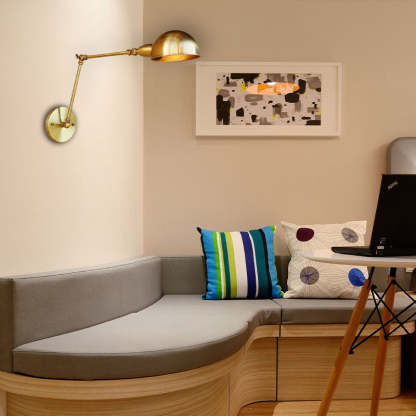 Bronze Swing Arm Wall Lamp over Living Room Couch