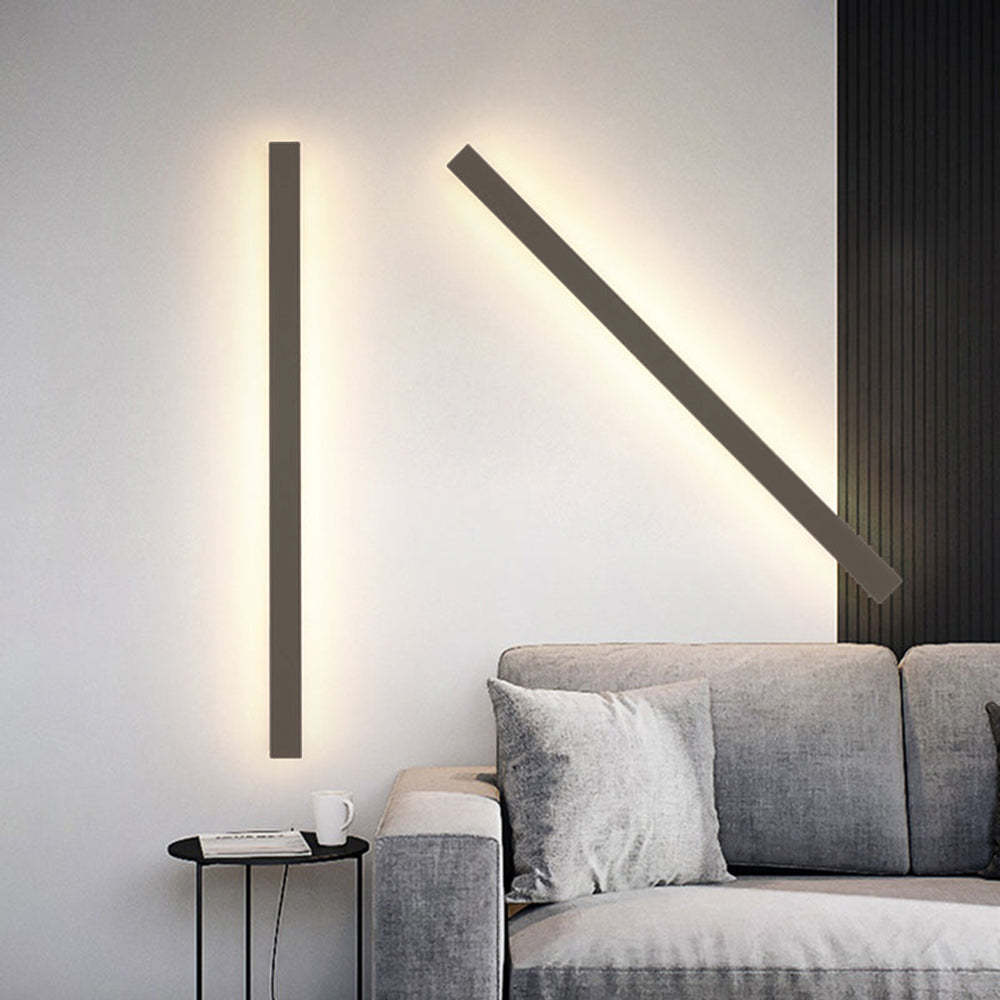 Minimalist wall sconce lighting above a sofa