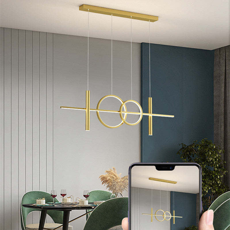 Geometric gold Madina pendant light over dining table