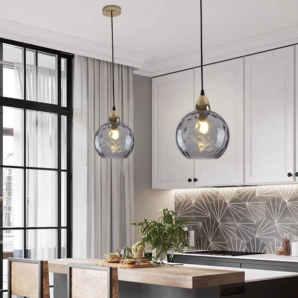 Gray glass pendant lights over kitchen island. Hailie style.
