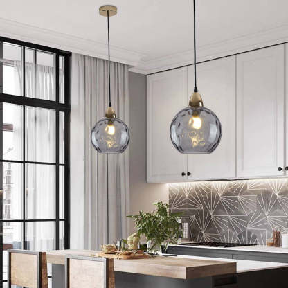 Gray glass pendant lights over kitchen island. Hailie style.