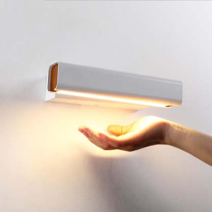 Aqsa Modern Wall Lamp lighting a hand.