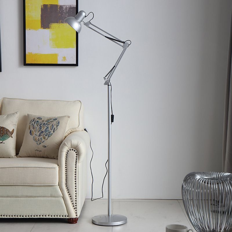 Modern silver floor lamp beside a sofa in living room