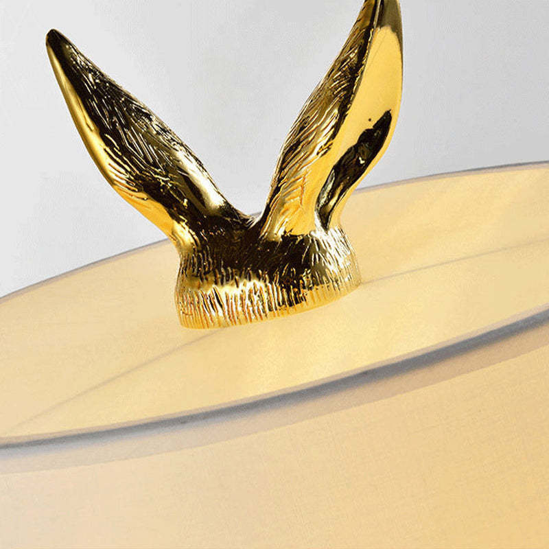 Close up of gold rabbit ears on Las Sola table lamp.