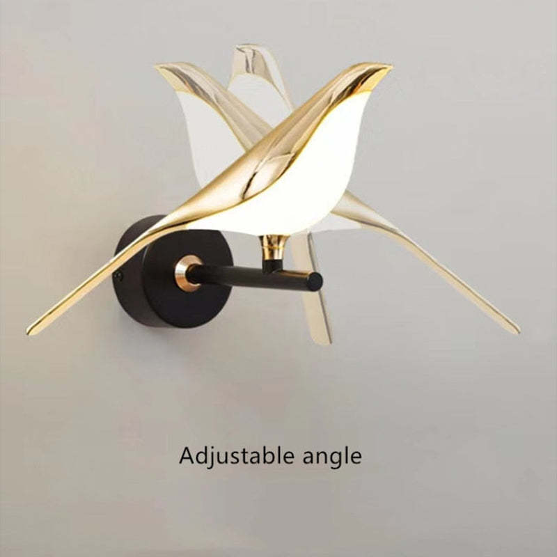 Clifford gold bird wall lamp with adjustable angle.
