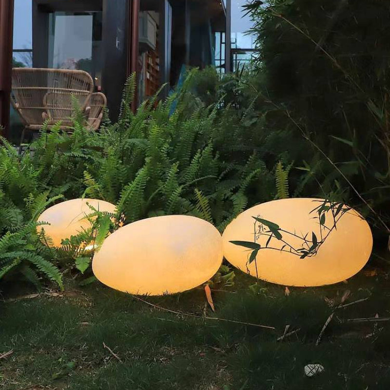 Las Sola Pena stone outdoor light on lawn. Pena Modern Stone Shaped Rechargeable Outdoor Light