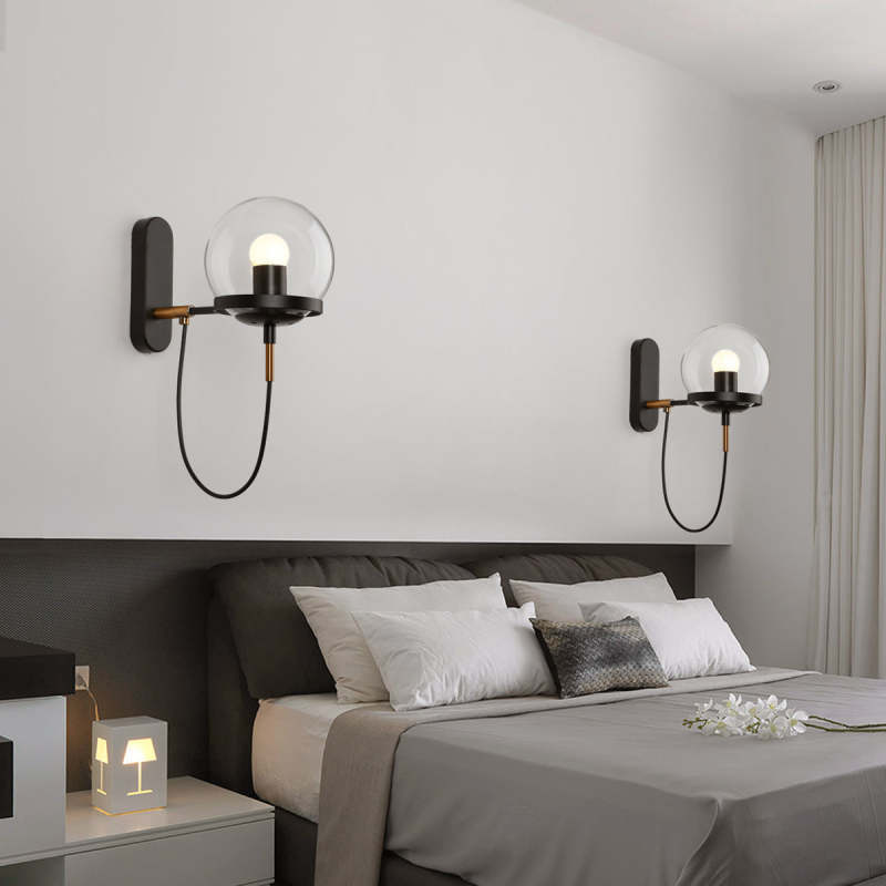 Alessio glass globe wall lamp in bedroom.