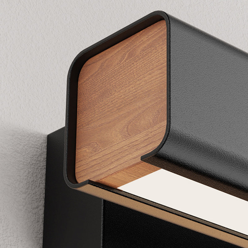 Close-up of Aqsa black metal & wood rotatable wall lamp.