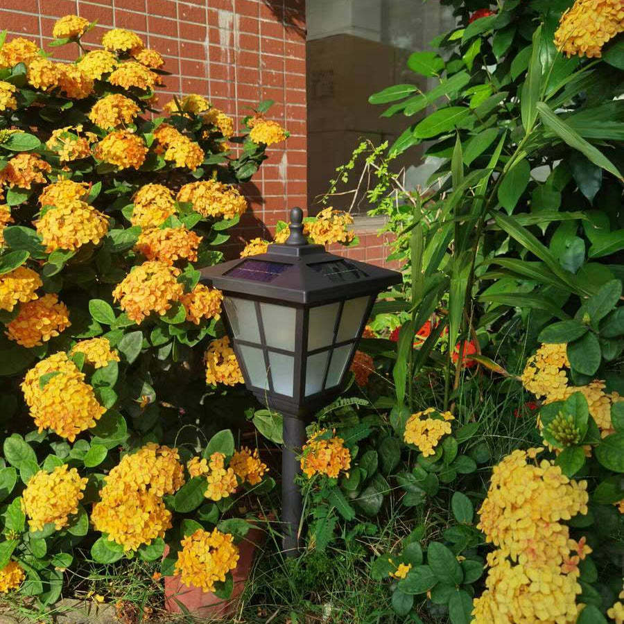 Pena Solar Bollard Light in Garden with flowers