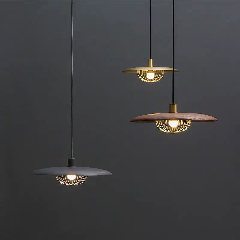 Cairns metal pendant lights in gold, wood and gray.