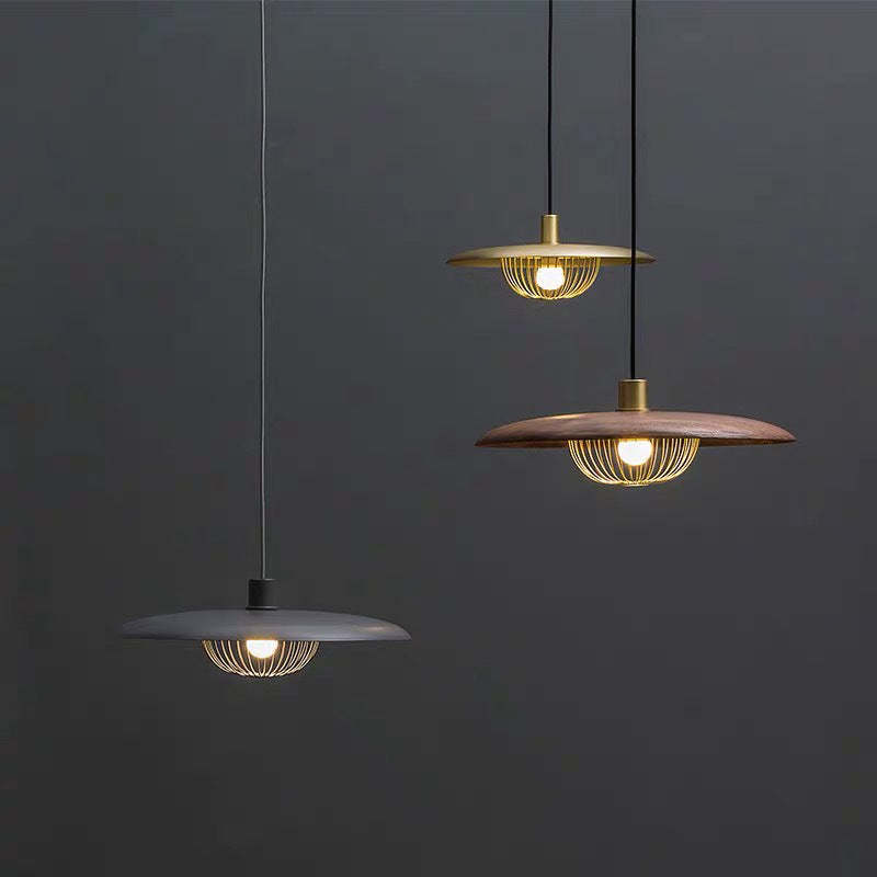 Cairns metal pendant lights in gold, wood and gray.