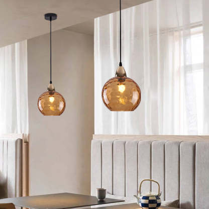 Amber glass ball pendant light in dining room