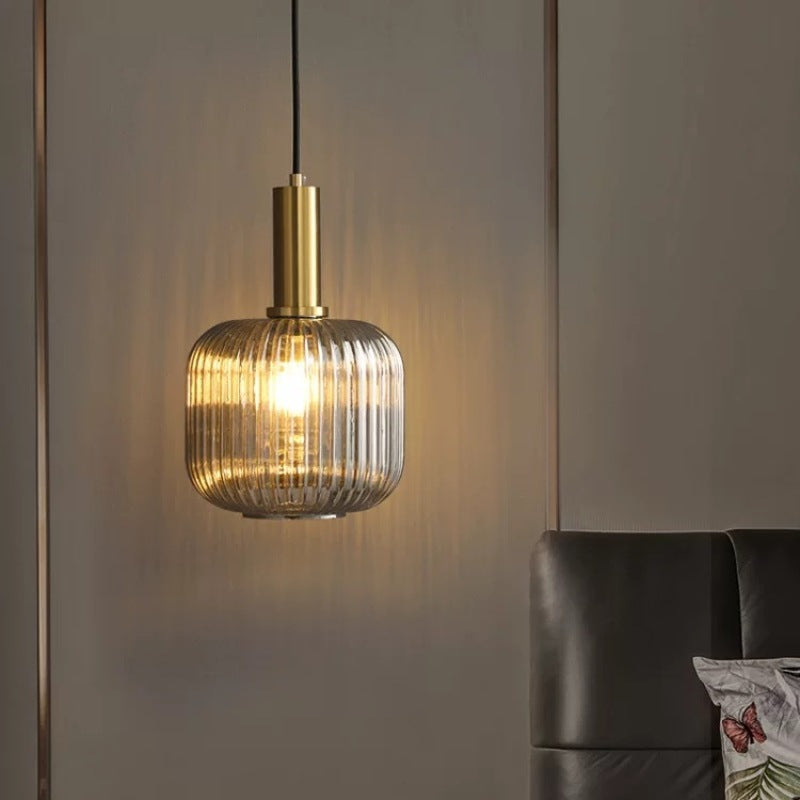 Hailie glass pendant light in bedroom setting.