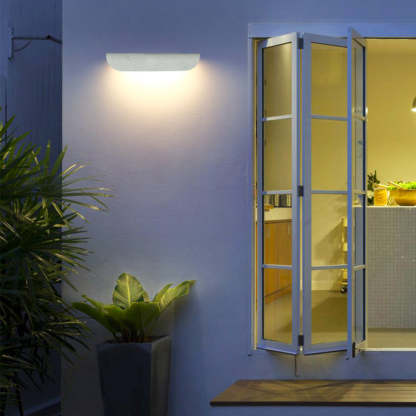 Orr Modern Curved Outdoor Wall Lamp illuminating exterior at dusk