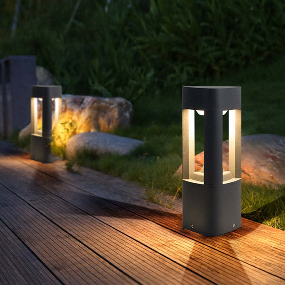 Pena Outdoor Path Light illuminating wooden deck
