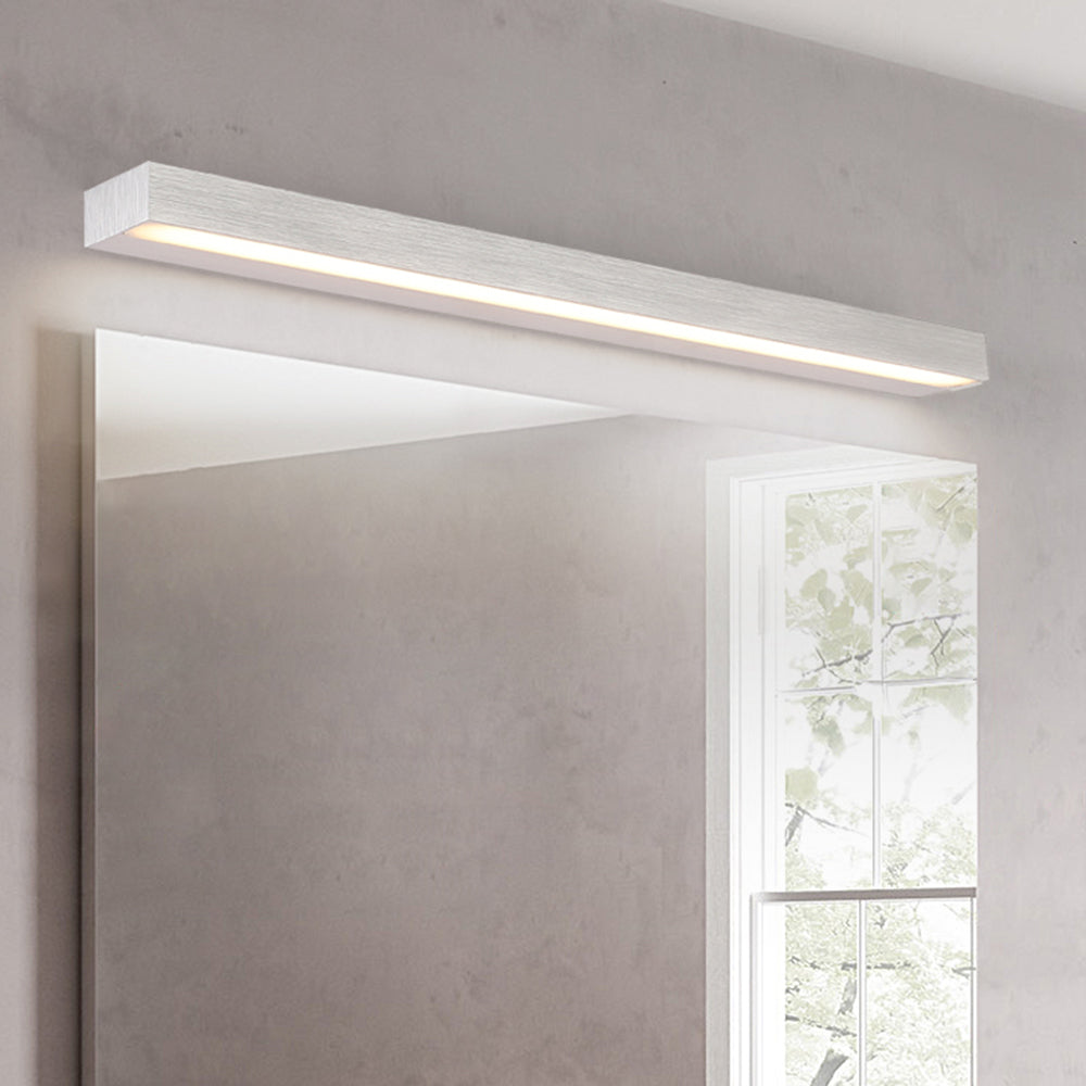 Linear LED wall lamp above mirror in bathroom