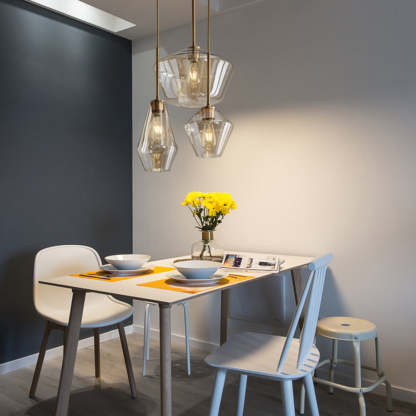 Hailie glass pendant lights above dining table.