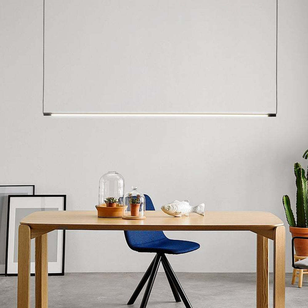 Linear pendant light over modern dining table