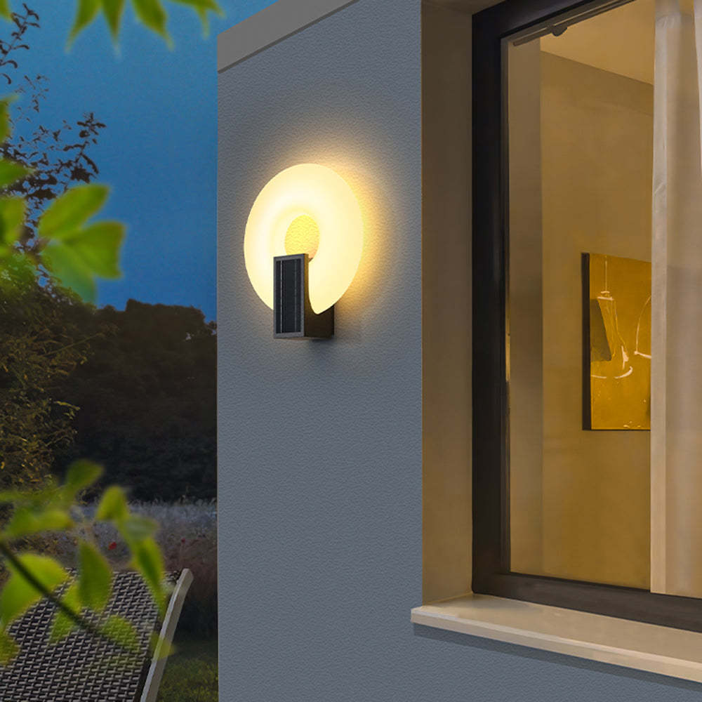 Isaac solar outdoor wall lamp illuminating exterior at night