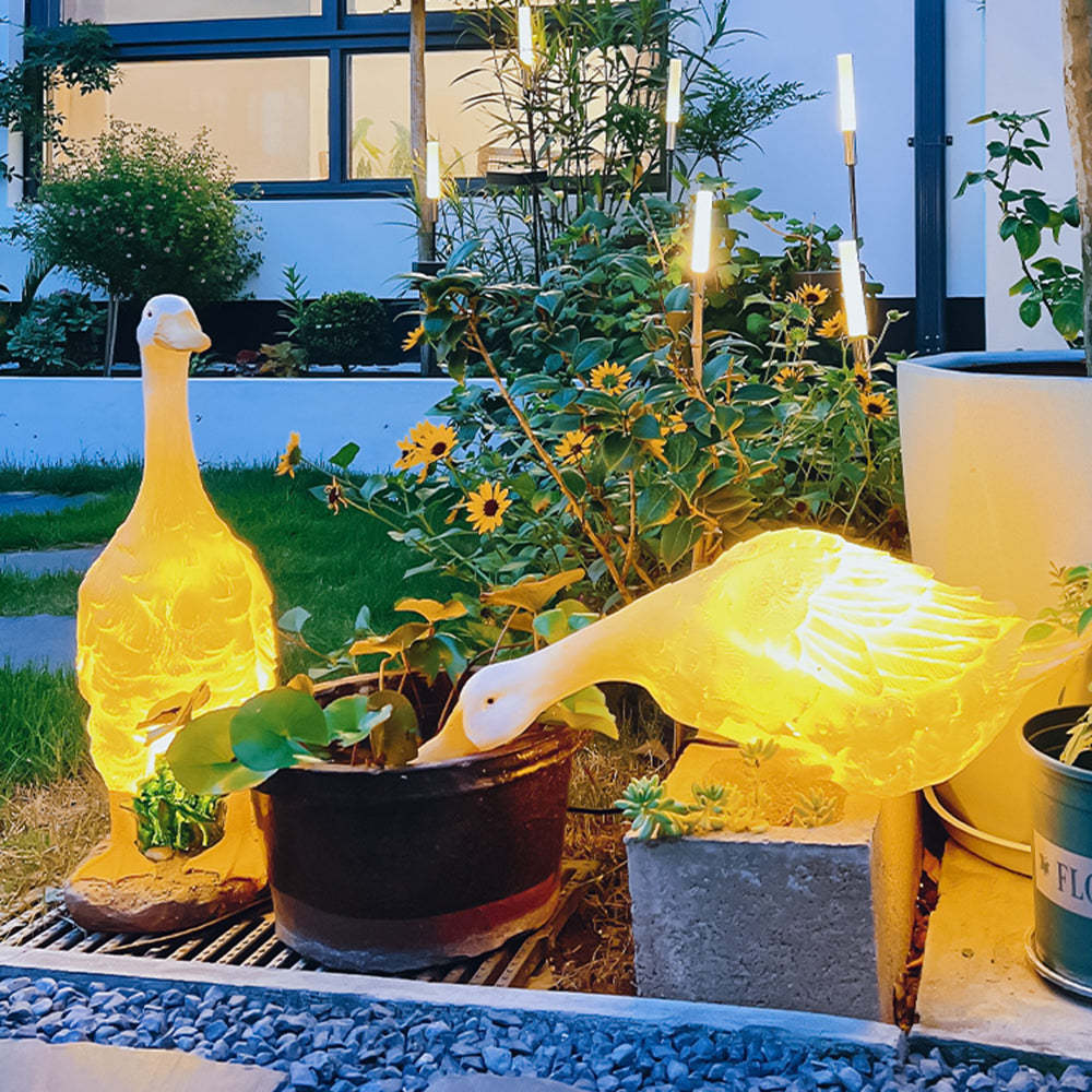 Glowing goose garden lights in outdoor setting