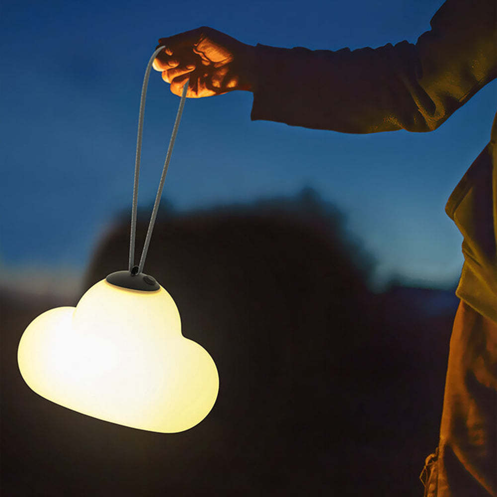 Hand holds cloud light. Modern outdoor pendant lighting.