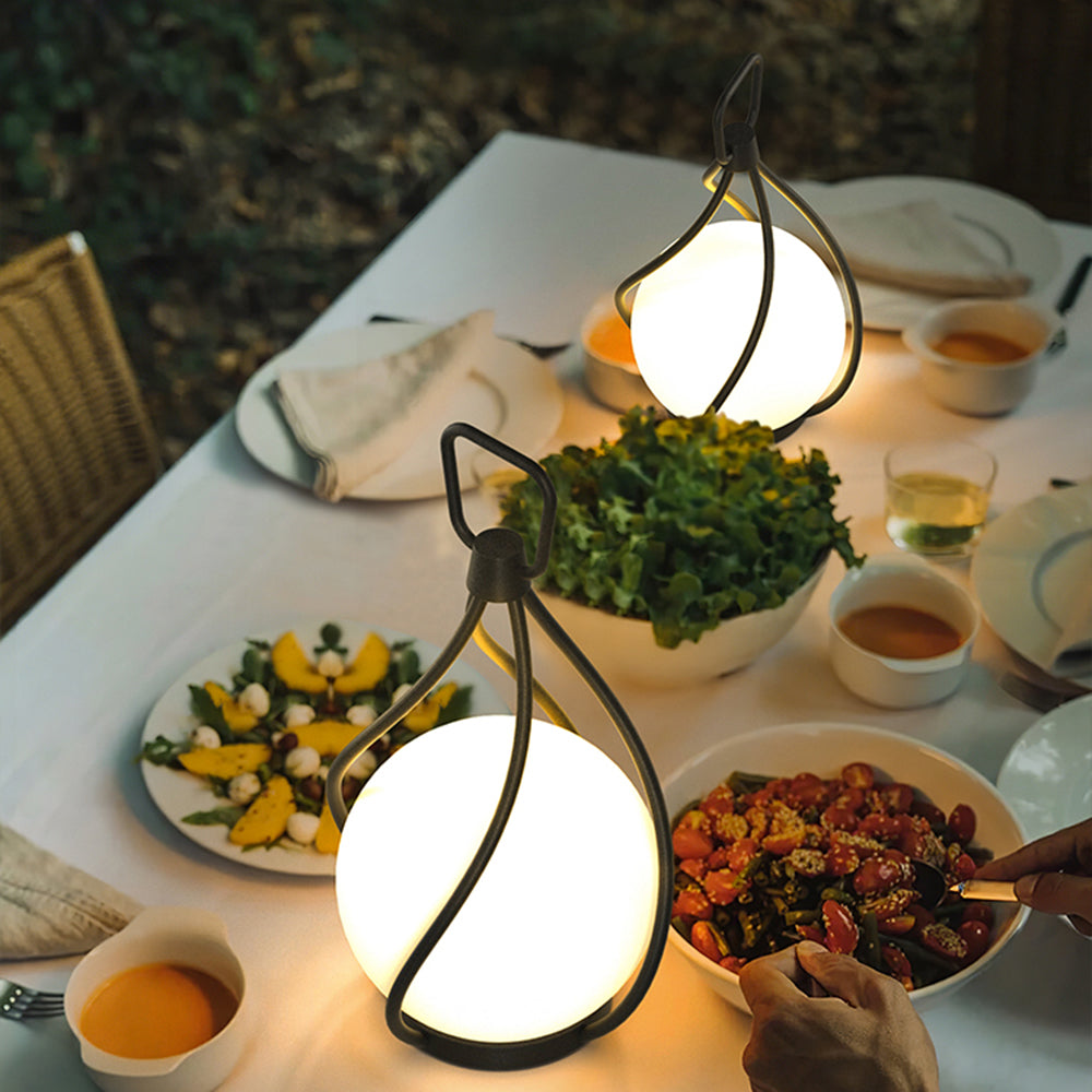 Outdoor dining table with Valentina pendant lights illuminating