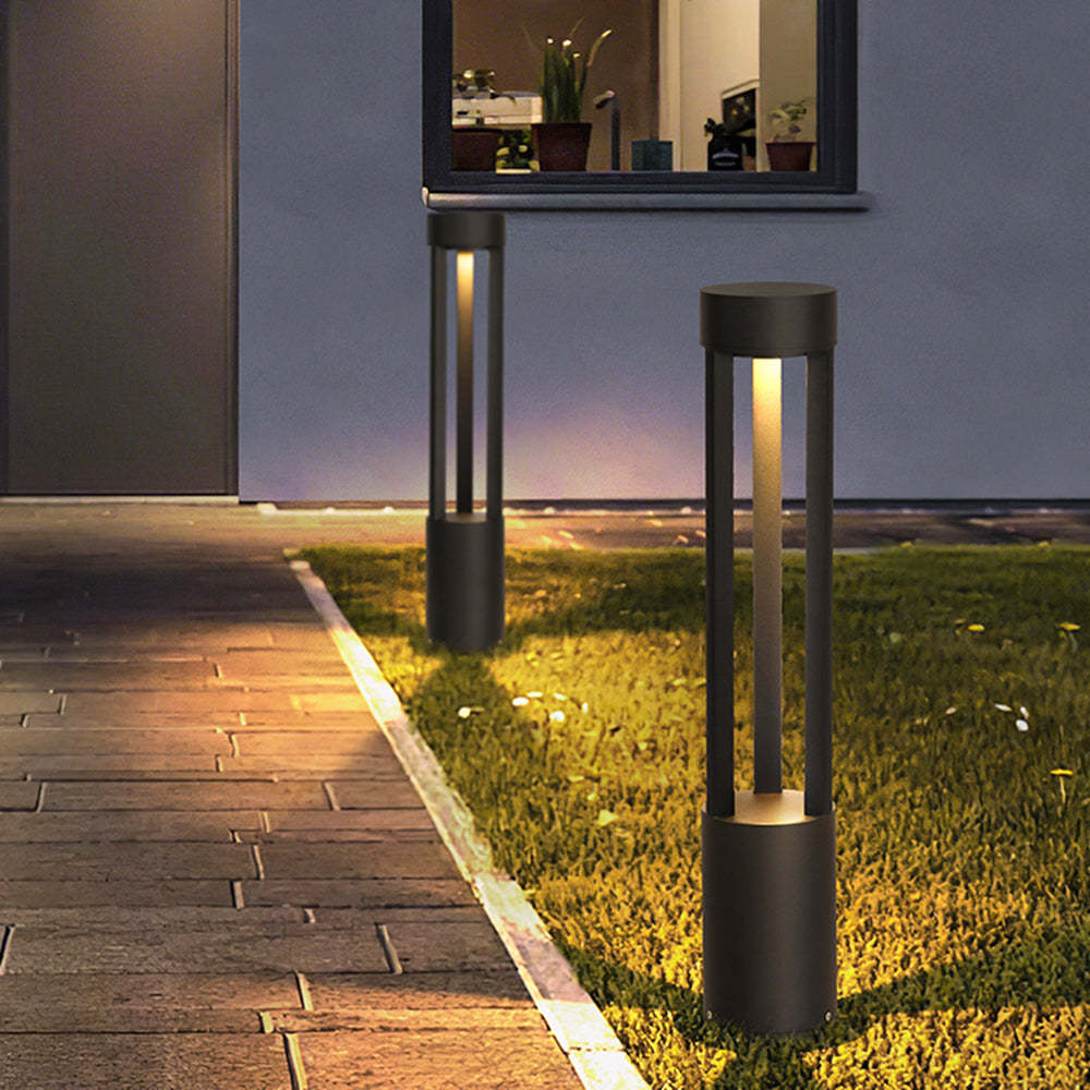 Outdoor Pena path lights illuminating pathway and garden