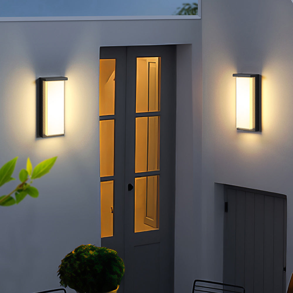 Modern outdoor wall lamps illuminating a garden entrance