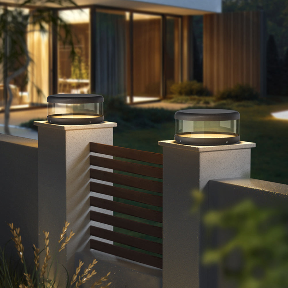 Outdoor pillar lights on a garden wall, warm light