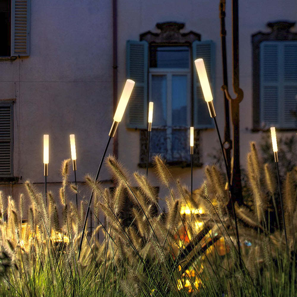 Pena modern outdoor post lights illuminating garden at night