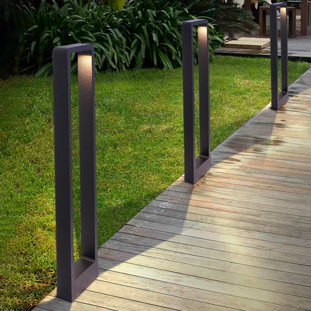 Modern outdoor path lights illuminate wooden pathway