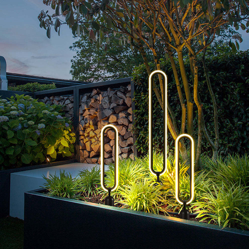 Pena Elliptical Ring Outdoor Path Lights illuminating garden at night