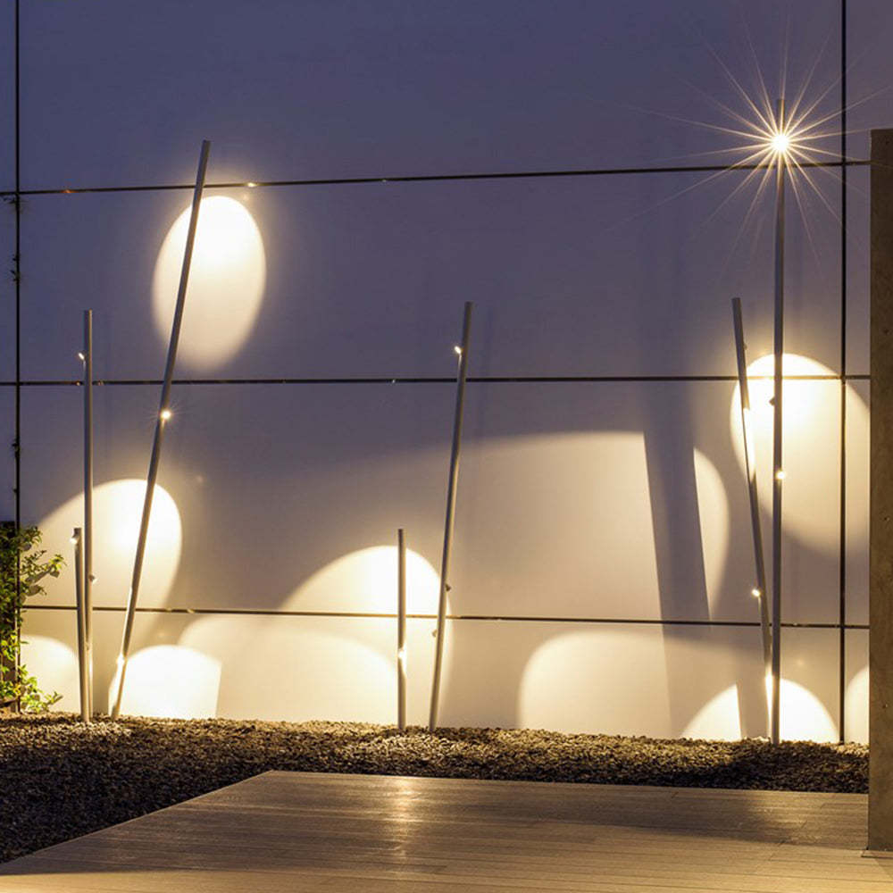 Las Sola Edge Bamboo Outdoor Floor Lamps illuminate modern garden.