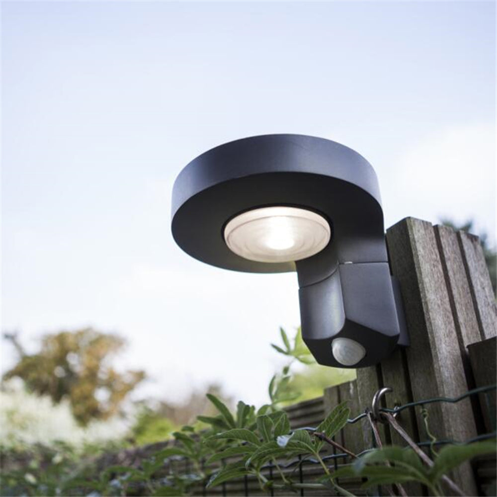 Orr solar wall lamp mounted on fence. Modern outdoor lighting.