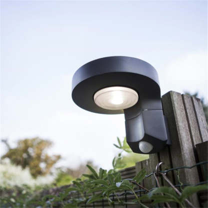 Orr solar wall lamp mounted on fence. Modern outdoor lighting.