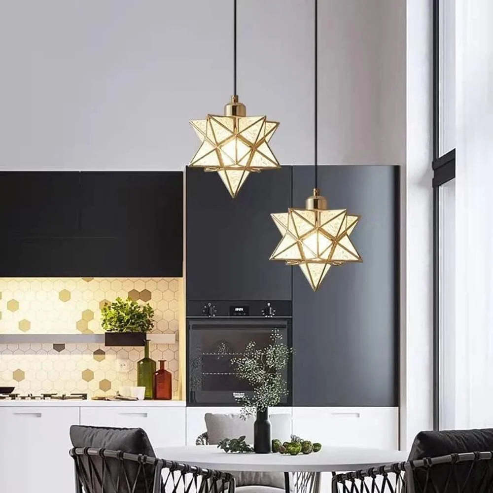 Gold star pendant lights over a dining room table