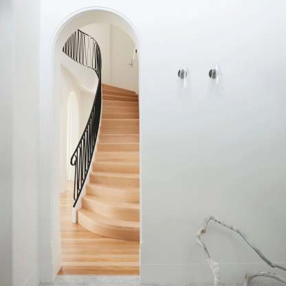 Blair Nordic wall lamps illuminate modern staircase. Glass & Metal fixture.