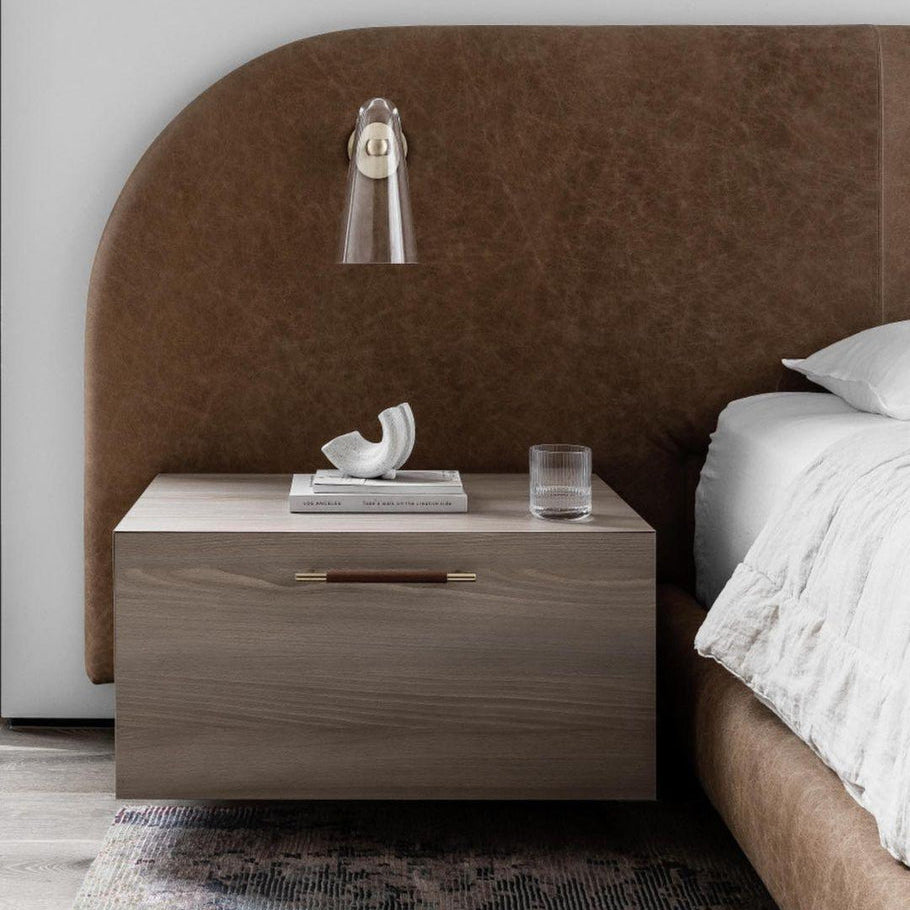 Nordic wall lamp in bedroom. Modern glass and metal lighting fixture.