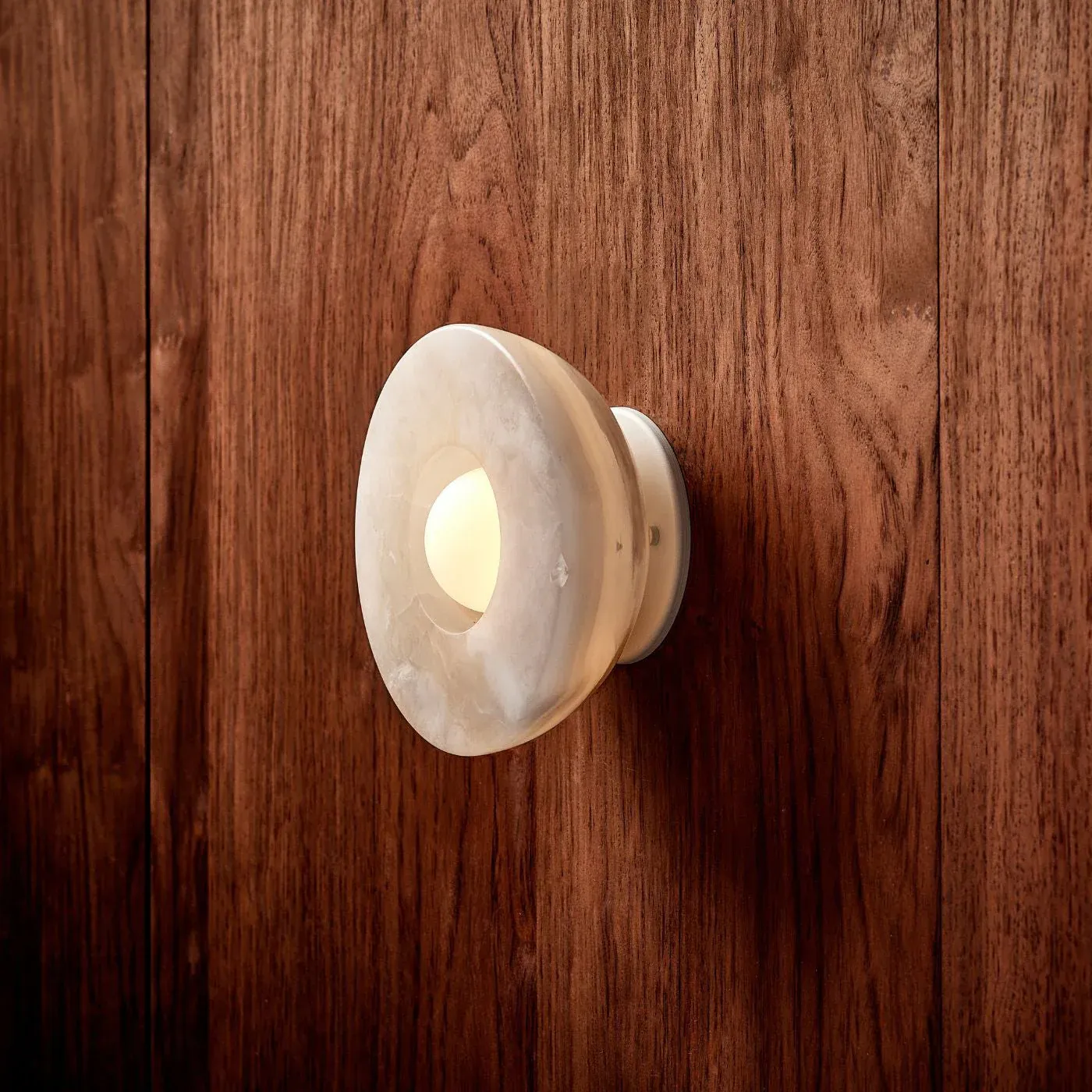 Elif Marble Wall Lamp, installed on a wooden wall