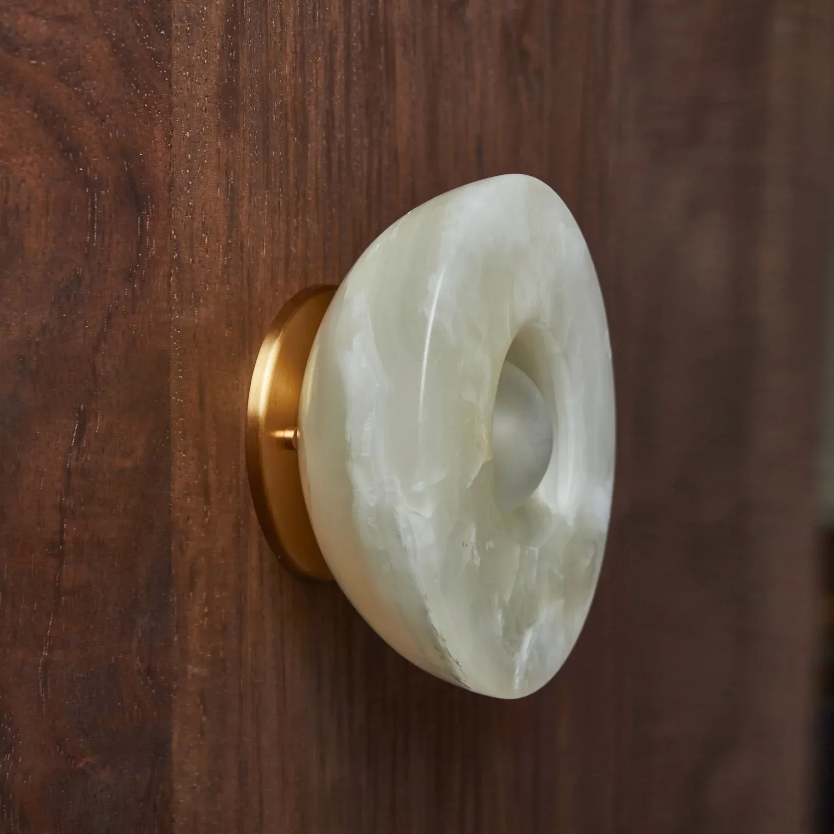 Elif Marble Wall Lamp detail on wooden wall, Lassola